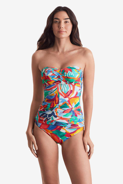 Woman wearing a multicolored floral bandeau tankini top with matching swim bottoms
