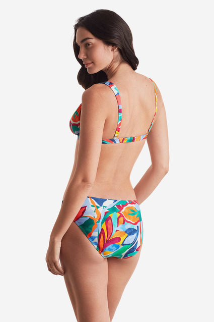 Woman turned left wearing a multicolored floral bikini top with matching swim bottoms