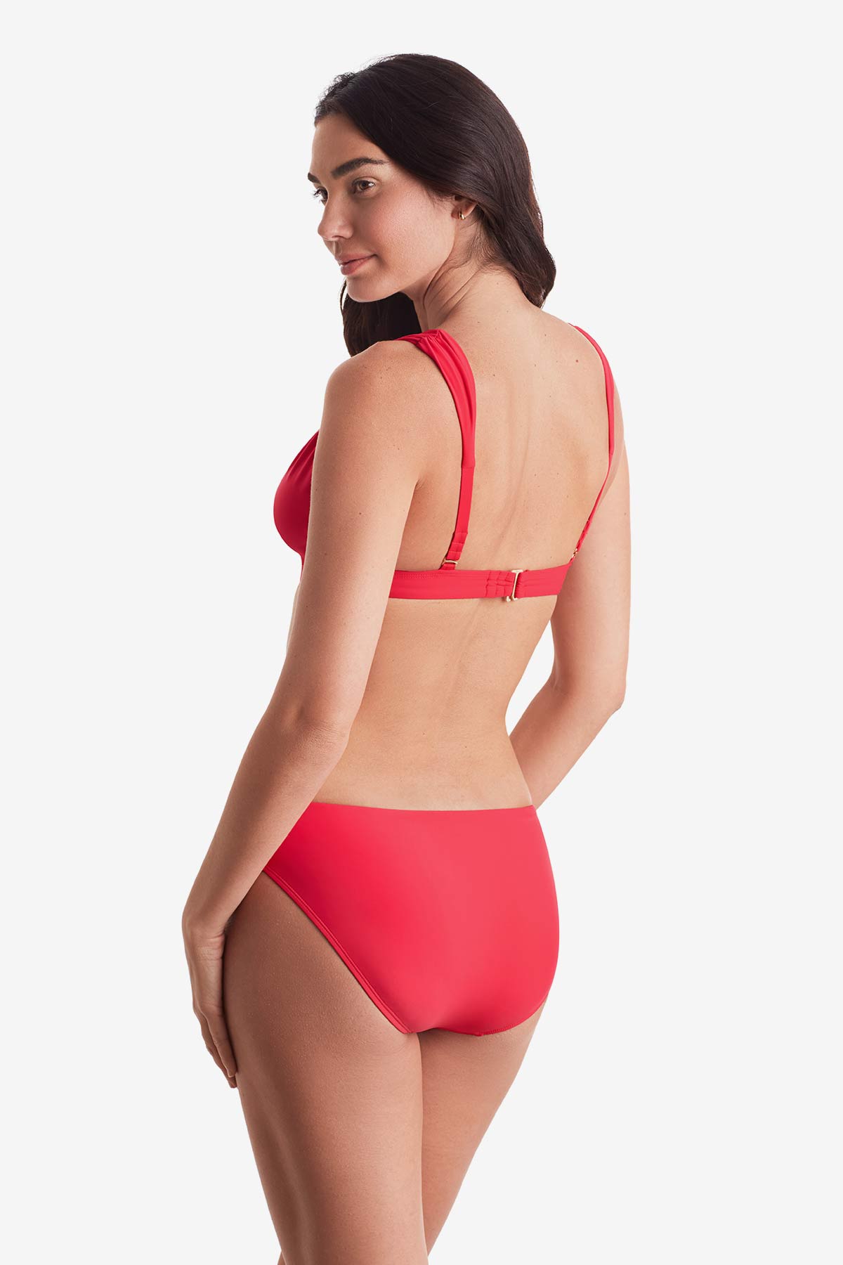 Woman turned left wearing a pink-orange bikini top with matching swim bottoms