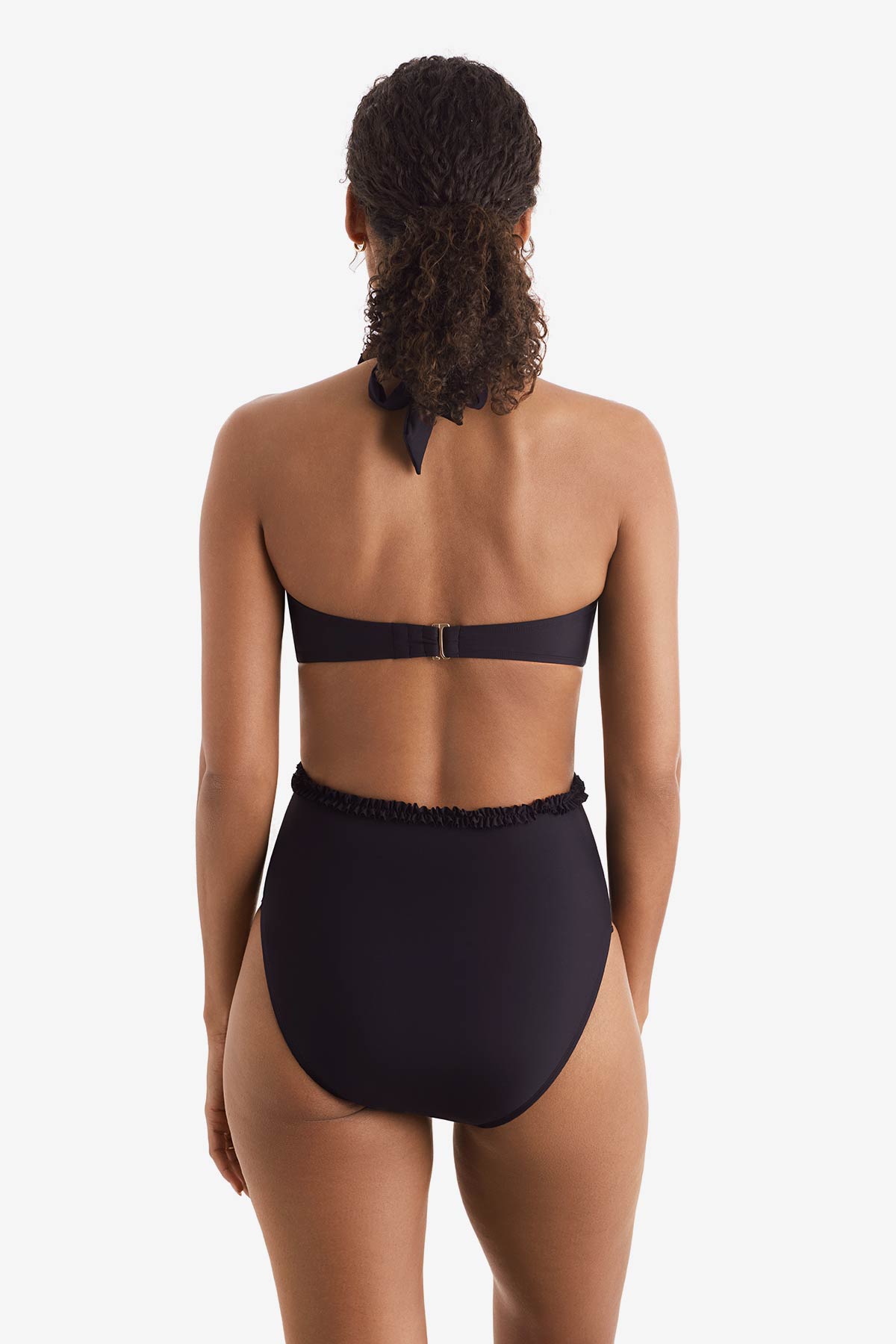 Woman faced away wearing a black one-piece swimsuit