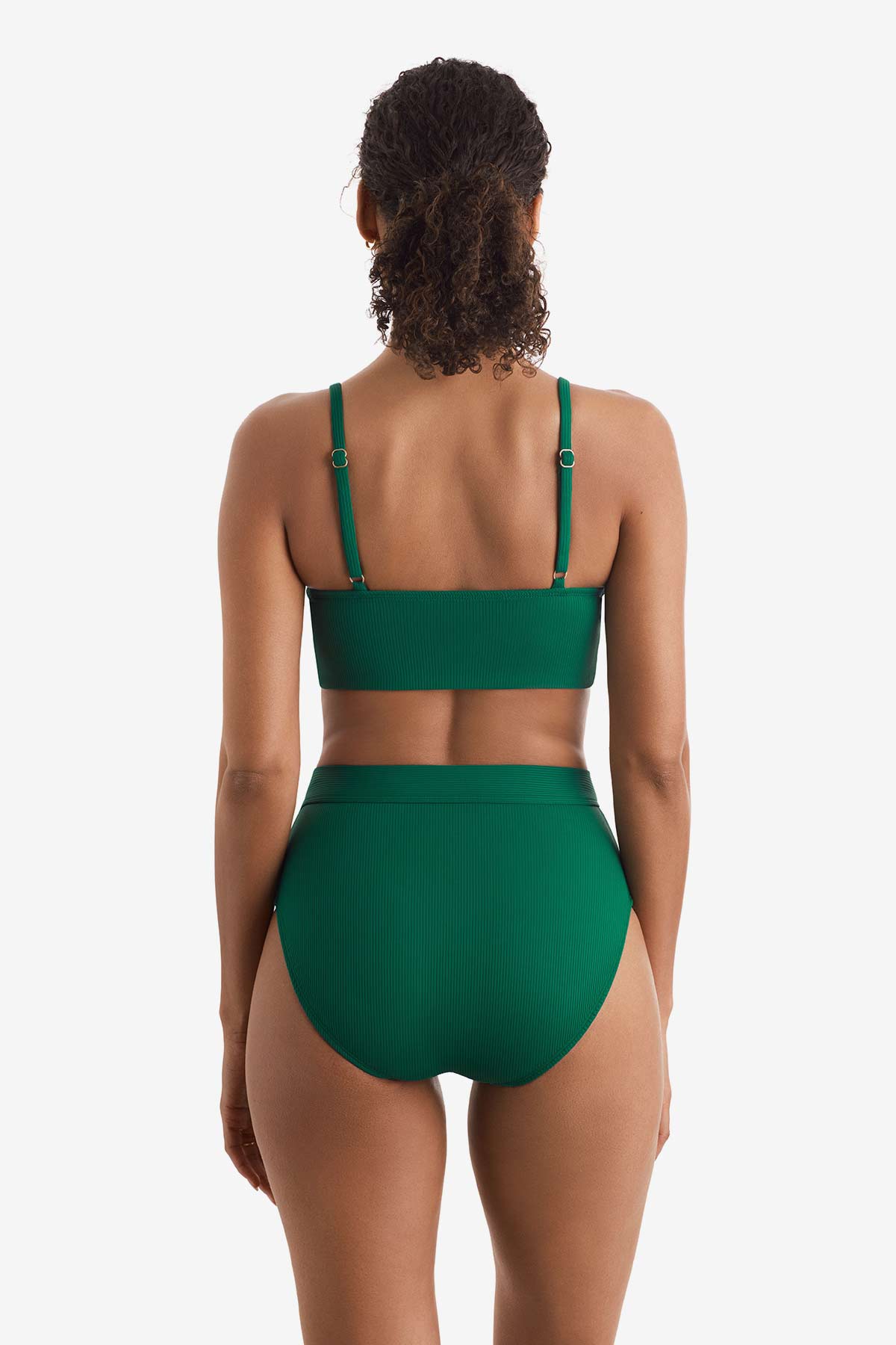 Woman turned away wearing a green midkini swim top with matching high-waisted swim bottoms