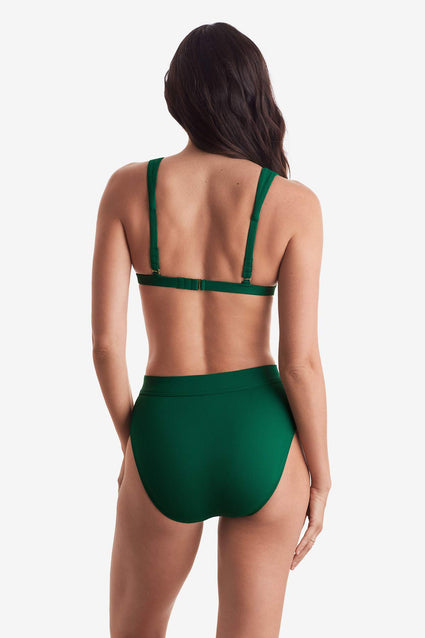Woman turned away wearing a green rib fabric bikini top with matching swim bottoms