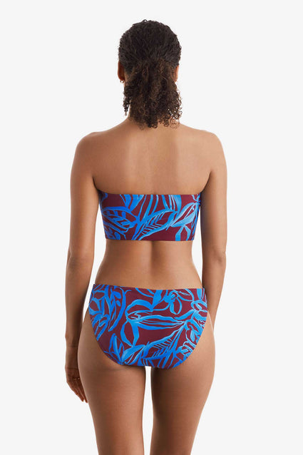 Woman faced away wearing a blue and brown abstract floral printed midkini swim top with matching swim bottoms