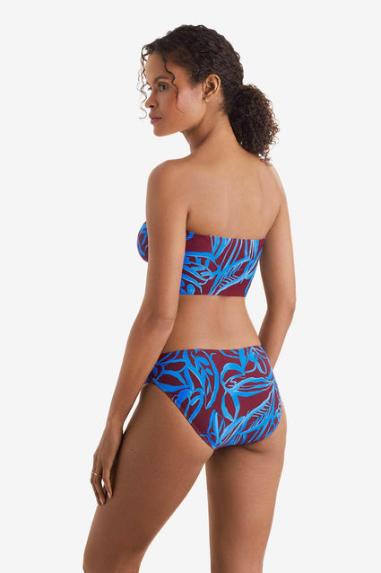 Woman faced left wearing a blue and brown abstract floral printed midkini swim top with matching swim bottoms