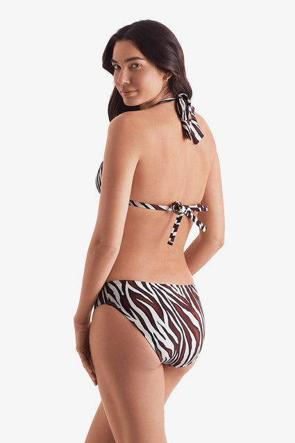 Woman turned left wearing a zebra print bikini top with zebra print swim bottoms