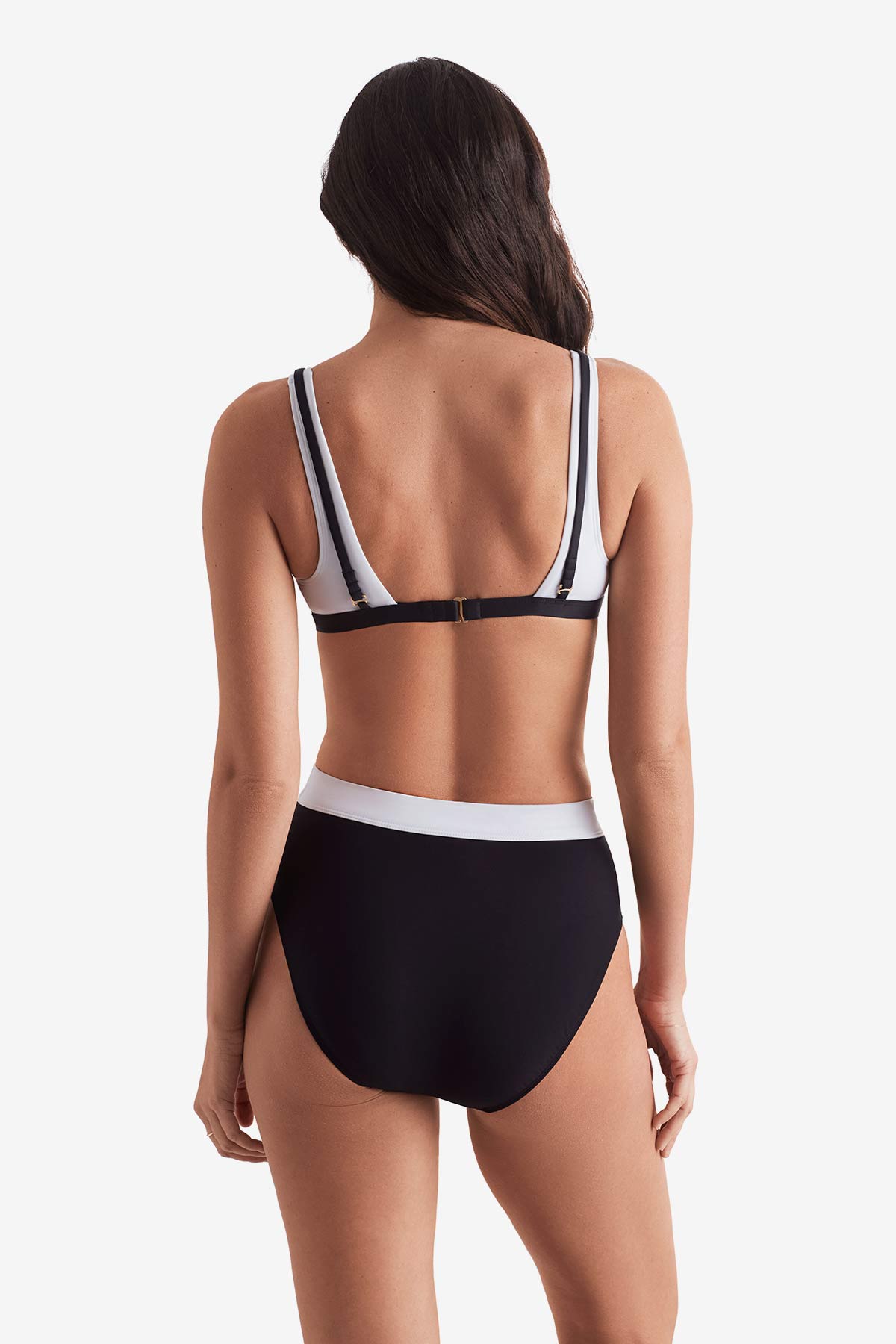 Women turned away wearing a black and white bikini top and black and white swim bottoms