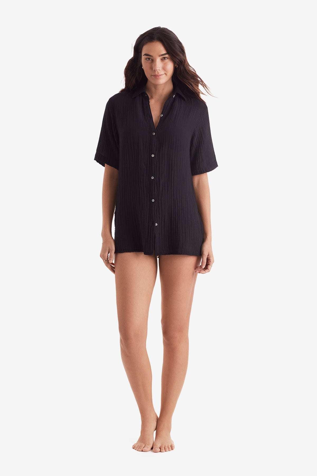 Woman wearing a black short sleeve button up shirt