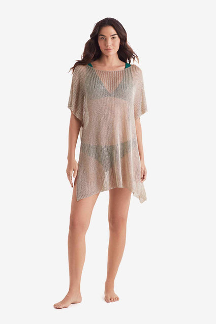 Woman wearing a tunic swim dress cover up in metallic gold