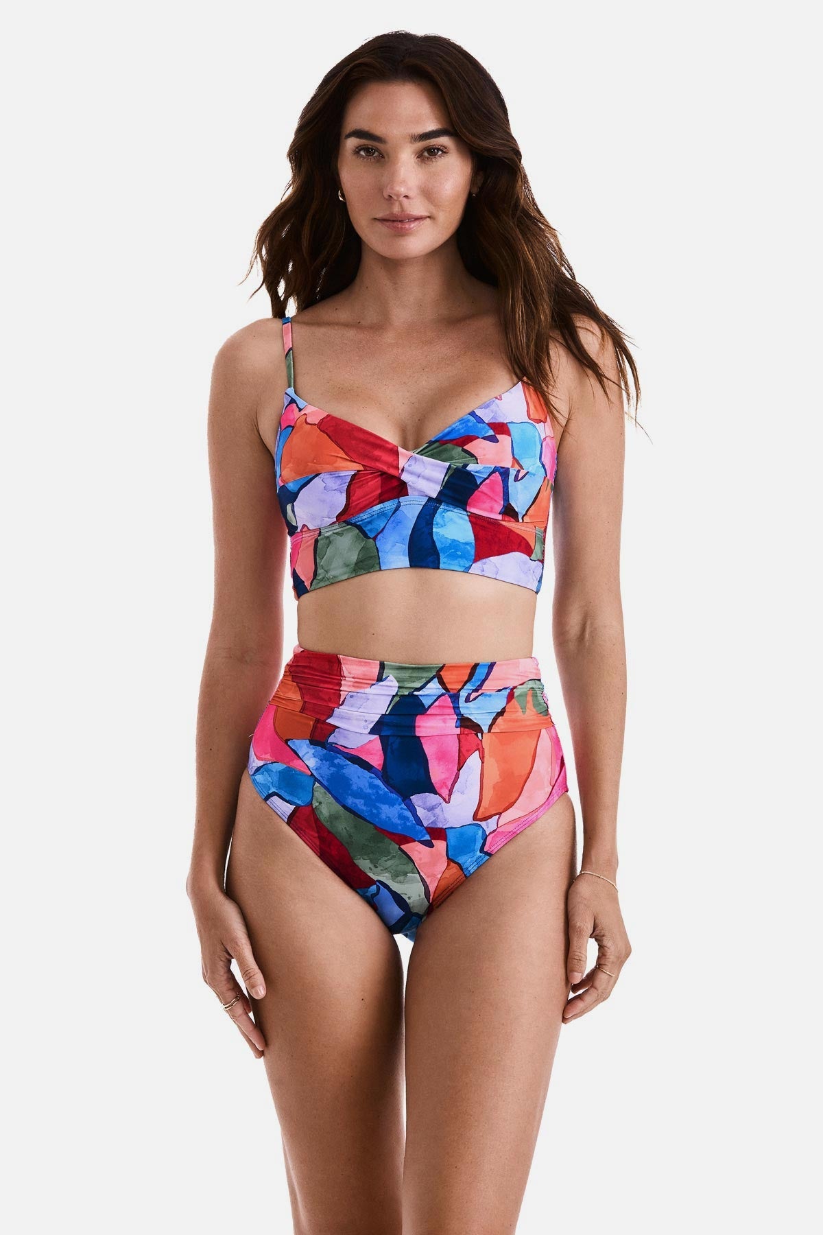 Woman wearing a multicolored abstract printed midkini swim top with matching swim bottoms