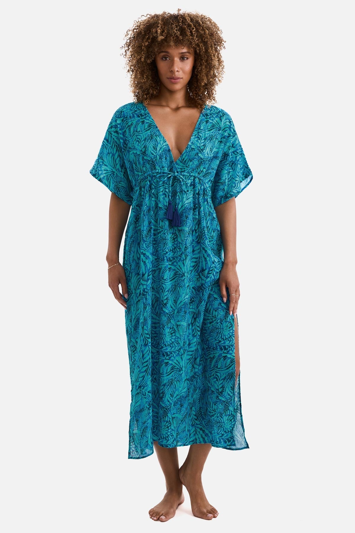 Woman wearing a blue abstract printed caftan swim cover up