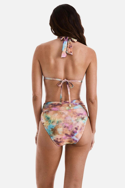 Woman turned away wearing a tie dye bikini top with matching swim bottoms