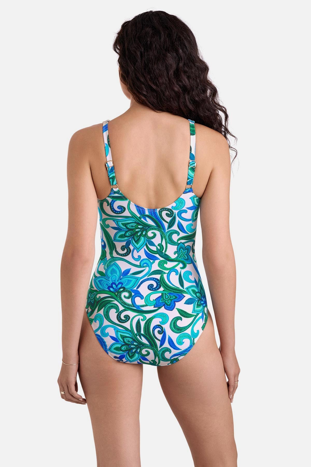Woman turned away wearing a blue and green floral printed one-piece swimsuit