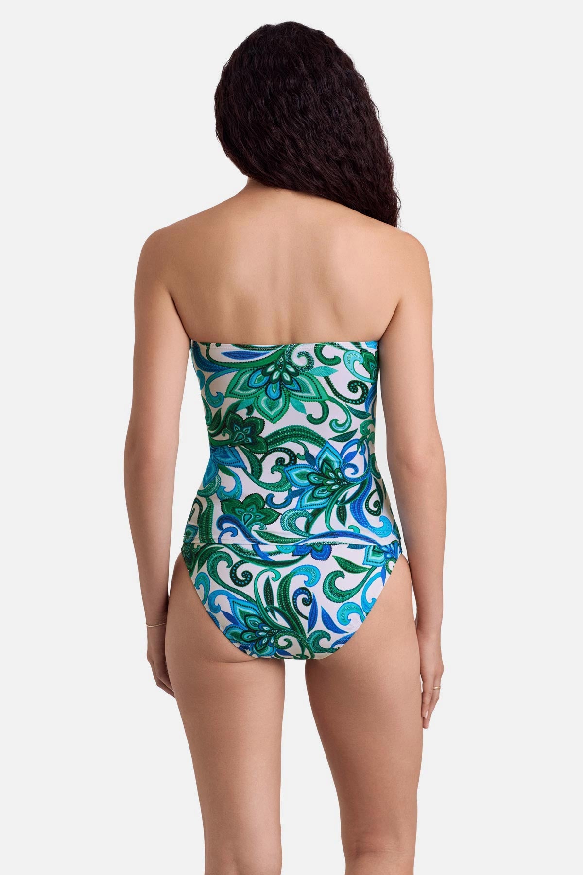 Woman turned away wearing a blue and green floral printed bandeau tankini top