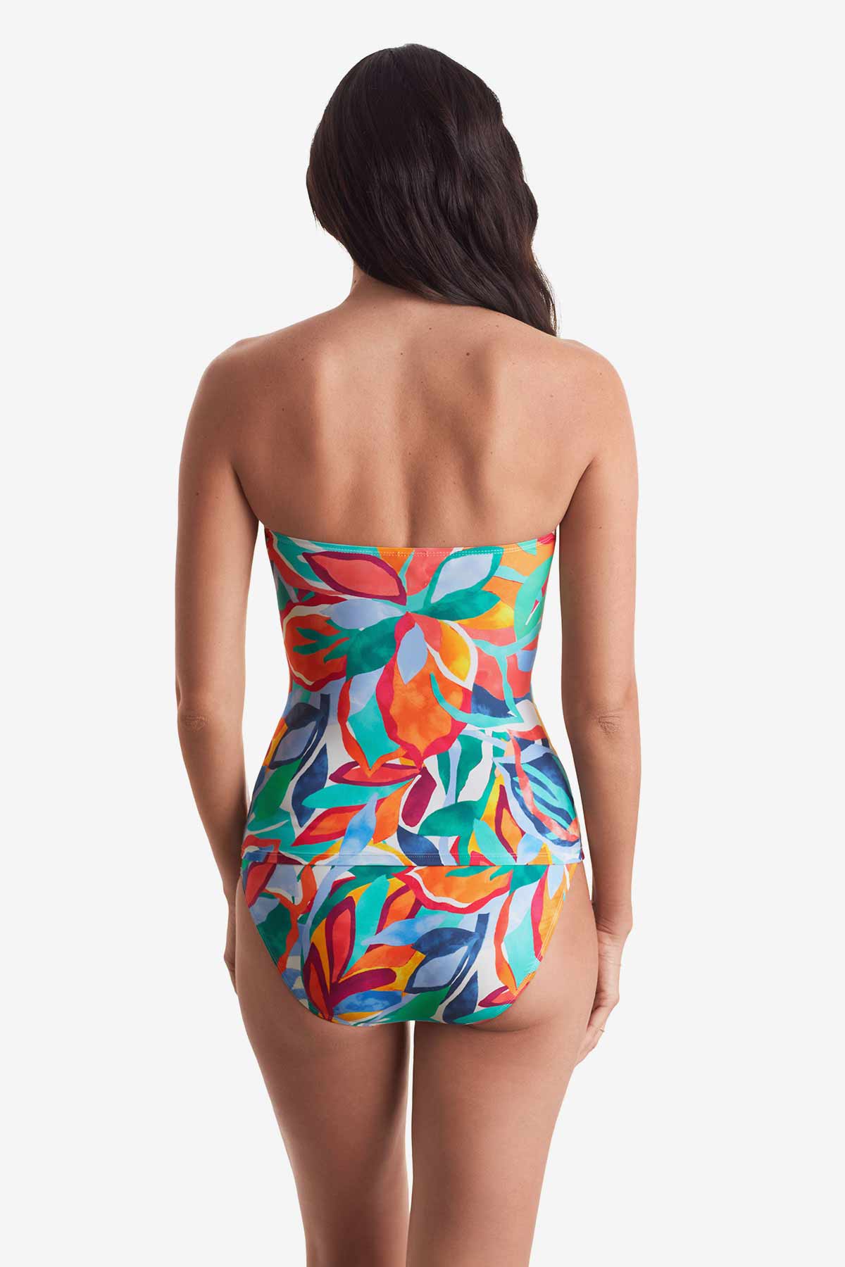 Woman turned away wearing a multicolored floral bandeau tankini top with matching swim bottoms
