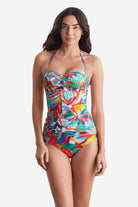 Woman wearing a multicolored floral bandeau tankini top with matching swim bottoms