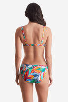 Woman turned away wearing a multicolored floral bikini top with matching swim bottoms