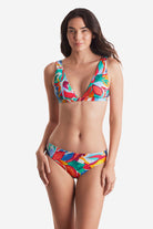 Woman wearing a multicolored floral bikini top with matching swim bottoms