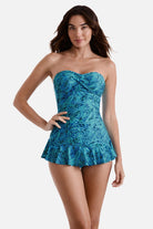 Woman wearing a blue abstract printed skirted one-piece swimsuit