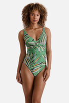Woman wearing a multicolored leaf printed one-piece swimsuit