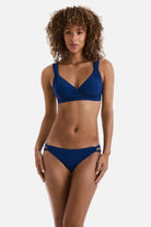 Woman wearing a dark blue bikini top with matching swim bottoms
