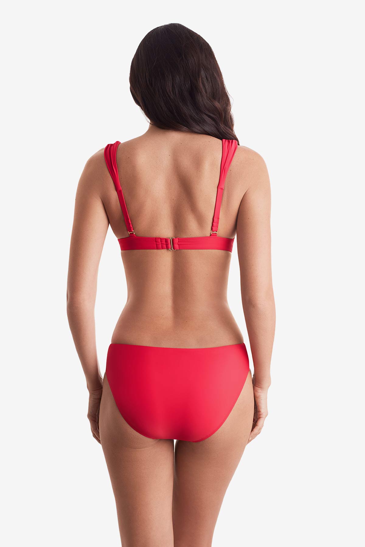 Woman turned away wearing a pink-orange bikini top with matching swim bottoms