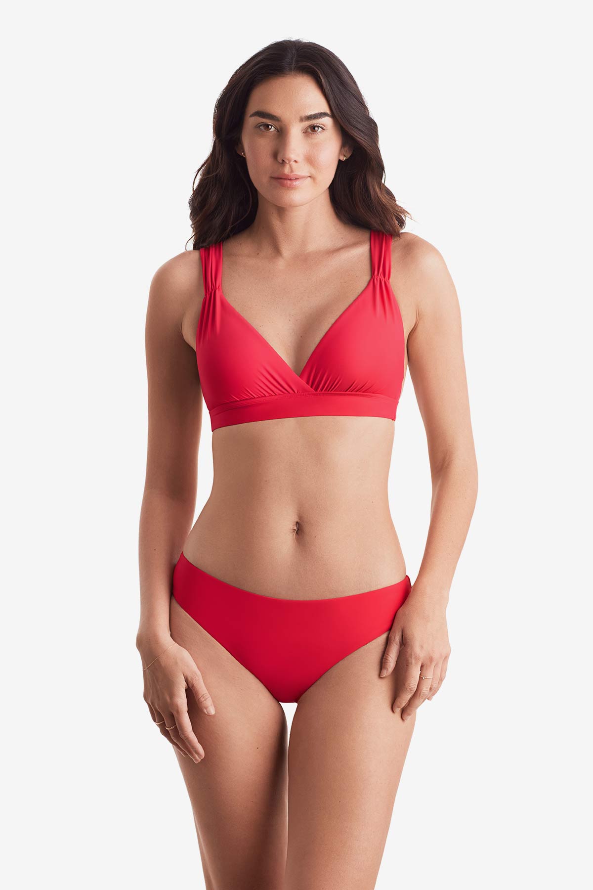 Woman wearing a pink-orange bikini top with matching swim bottoms