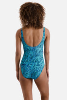 Woman turned away wearing a blue abstract printed one-piece swimsuit