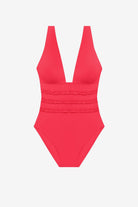 Orange-pink one-piece swimsuit with ruffles on the waist