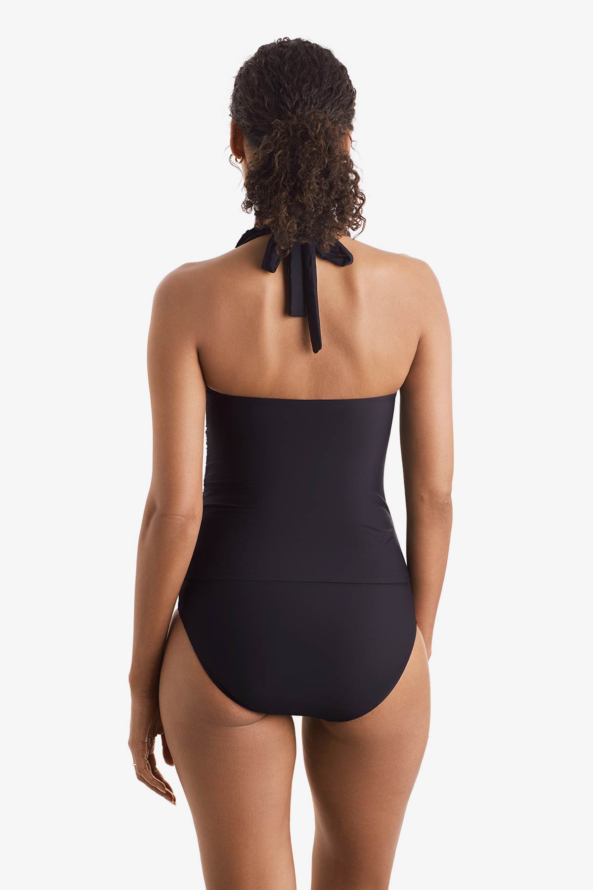 Woman turned away wearing a black tankini top
