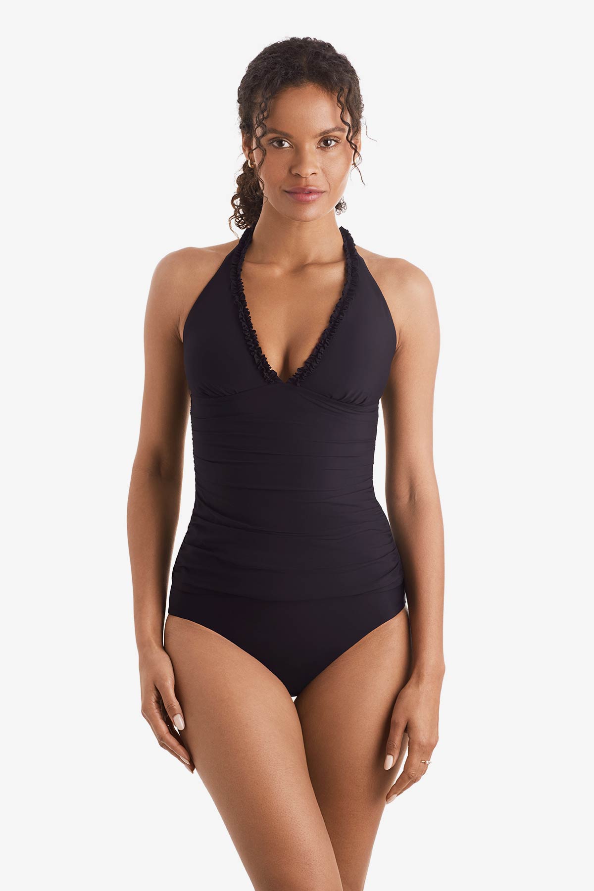 Woman wearing a black tankini top with ruffles on the neckline