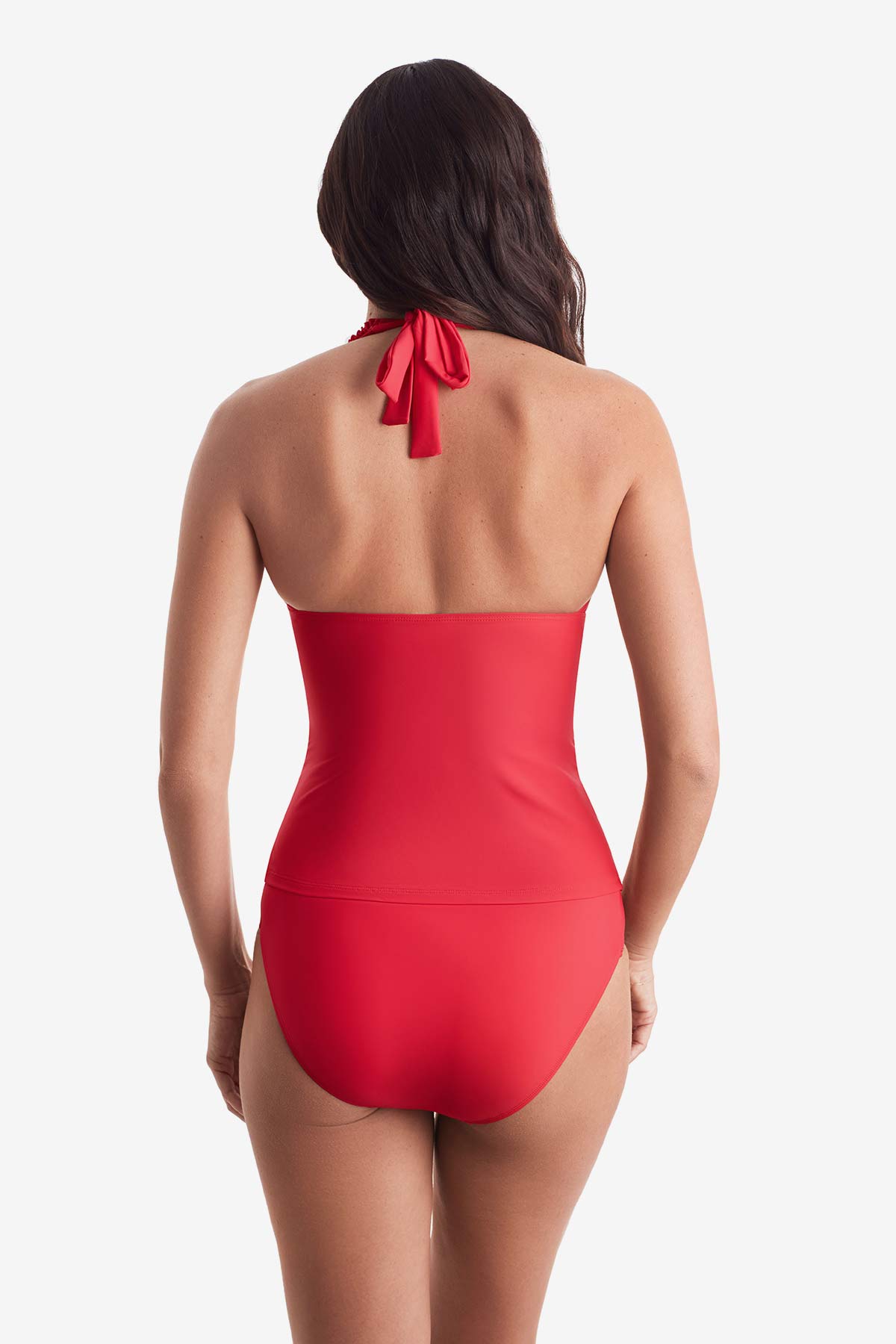 Woman turned away wearing a pink-orange tankini top with matching swim bottoms