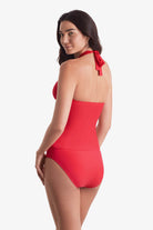 Woman faced left wearing a pink-orange tankini top with matching swim bottoms