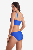 Woman turned left wearing a midkini swim top with matching swim bottoms