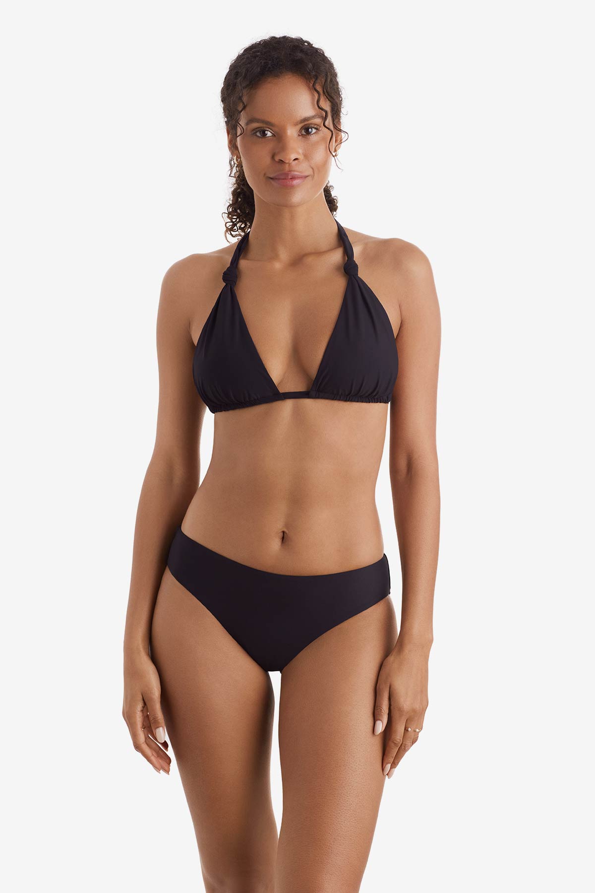 Woman wearing a black bikini top with black swim bottoms