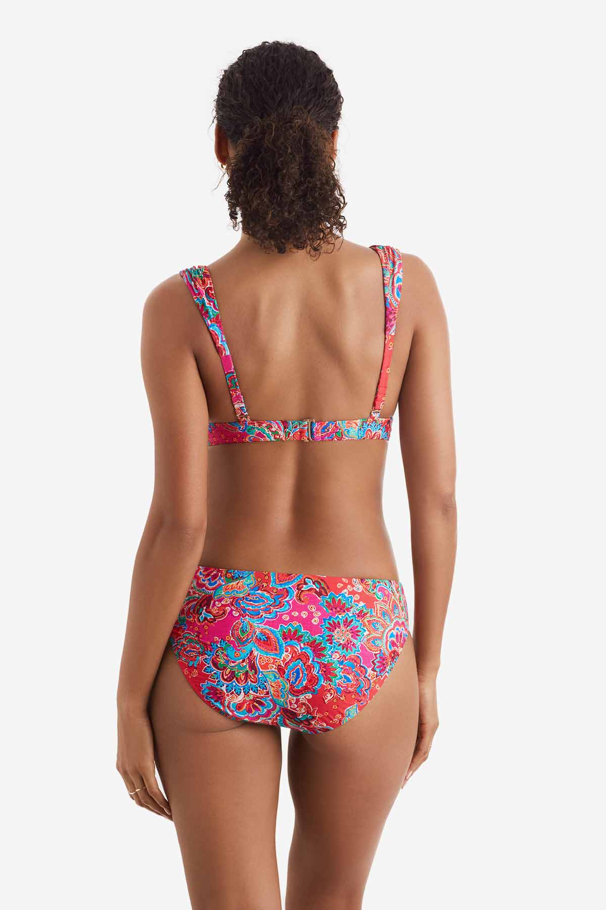 Woman turned away wearing a multicolor paisley print bikini top with matching swim bottoms