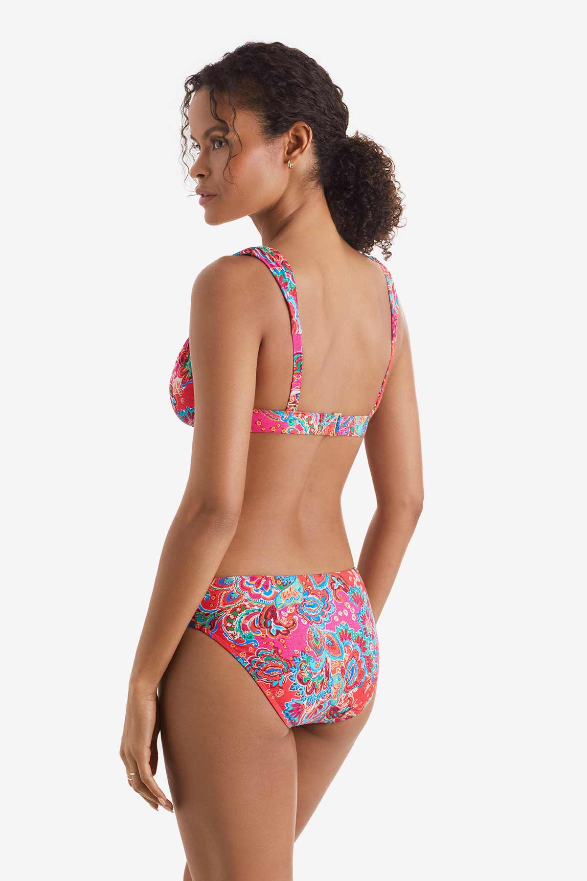 Woman turned left wearing a multicolor paisley print bikini top with matching swim bottoms
