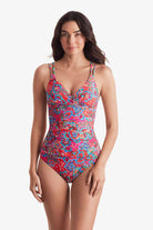 Woman wearing a multicolor paisley print tankini top with matching swim bottoms