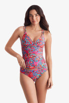 Woman wearing a multicolor paisley print tankini top with matching swim bottoms