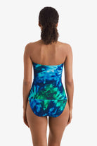 Women faced away wearing a blue and green tie dye bandeau tankini top