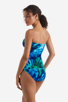 Women turned left wearing a blue and green tie dye bandeau tankini top