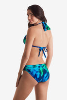 Woman turned left wearing a blue and green tie dye bikini top with matching swim bottoms
