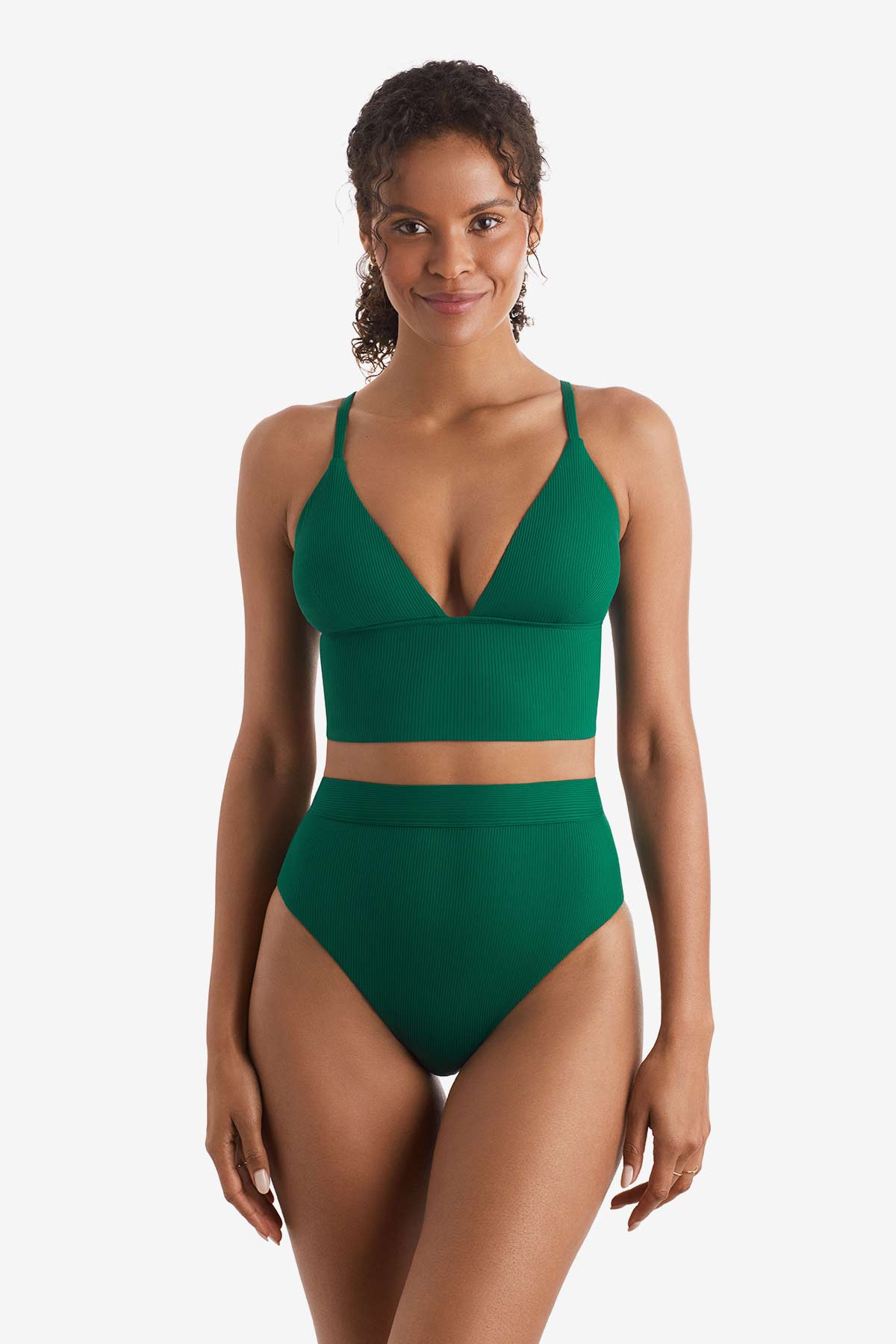 Woman wearing a green midkini swim top with matching high-waisted swim bottoms