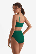 Woman turned left wearing a green midkini swim top with matching high-waisted swim bottoms