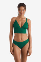 Woman wearing a green rib fabric midkini swim top with green rib fabric swim bottoms