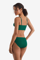 Woman turned left wearing a green rib fabric midkini swim top with green rib fabric swim bottoms