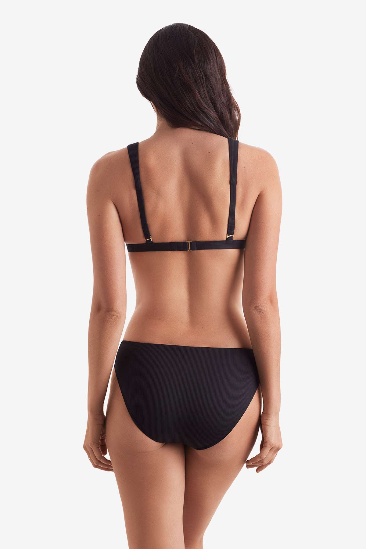 Woman faced away wearing a black bikini top with black swim bottoms