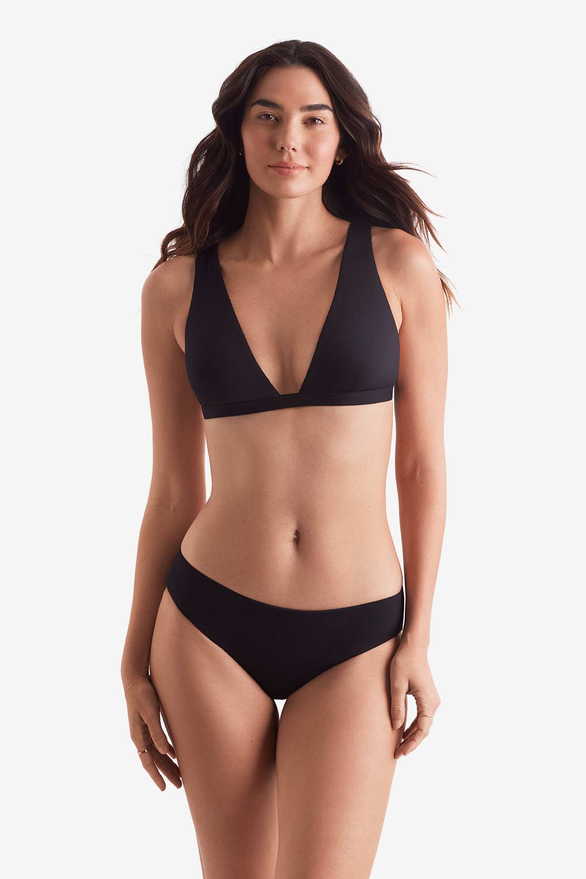 Woman wearing a black bikini top with black swim bottoms