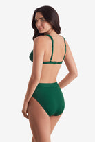 Woman turned left wearing a green rib fabric bikini top with matching swim bottoms