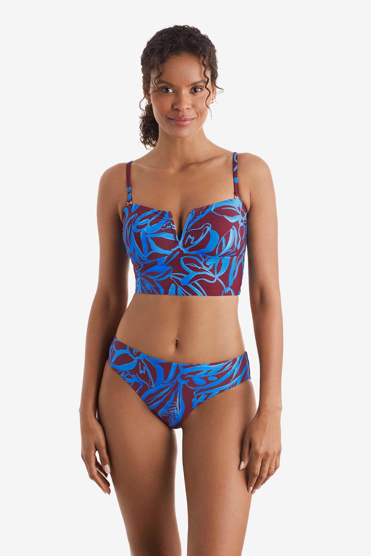 Woman wearing a blue and brown abstract floral printed midkini swim top with matching swim bottoms