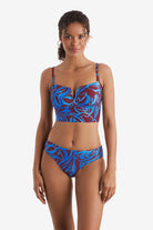 Woman wearing a blue and brown abstract floral printed midkini swim top with matching swim bottoms